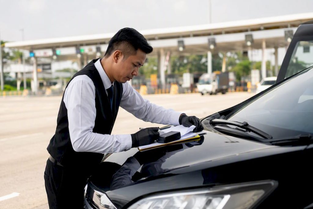 Chauffeur preparing vehicle documents at border