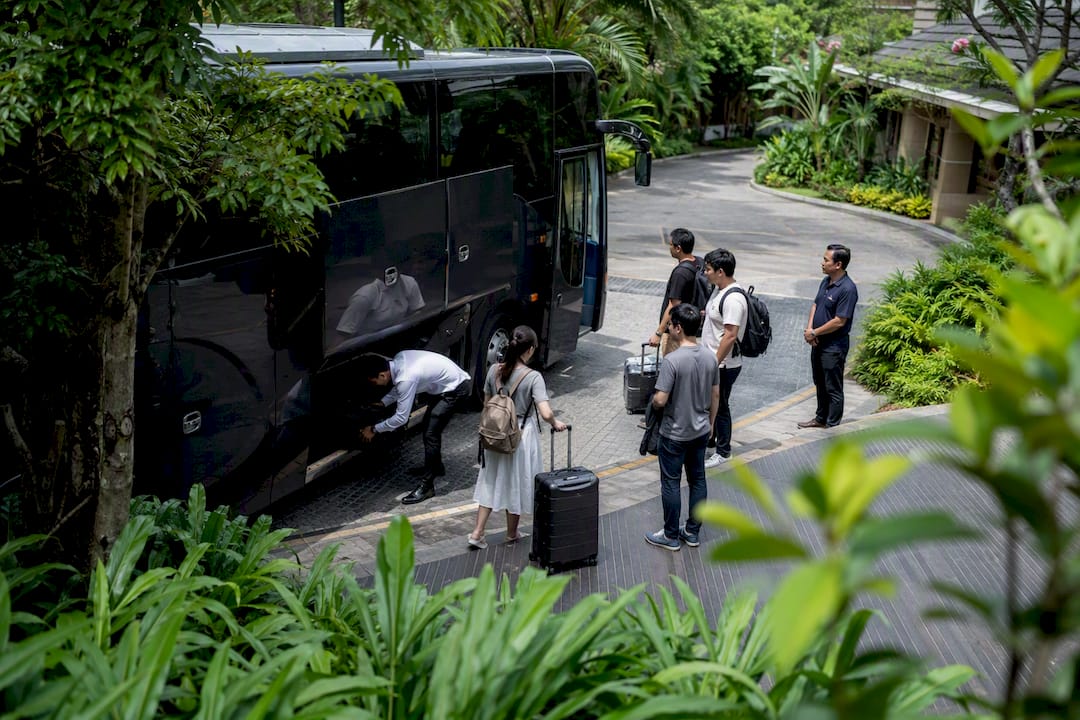 Group loading luggage into chalet coach at pick-up