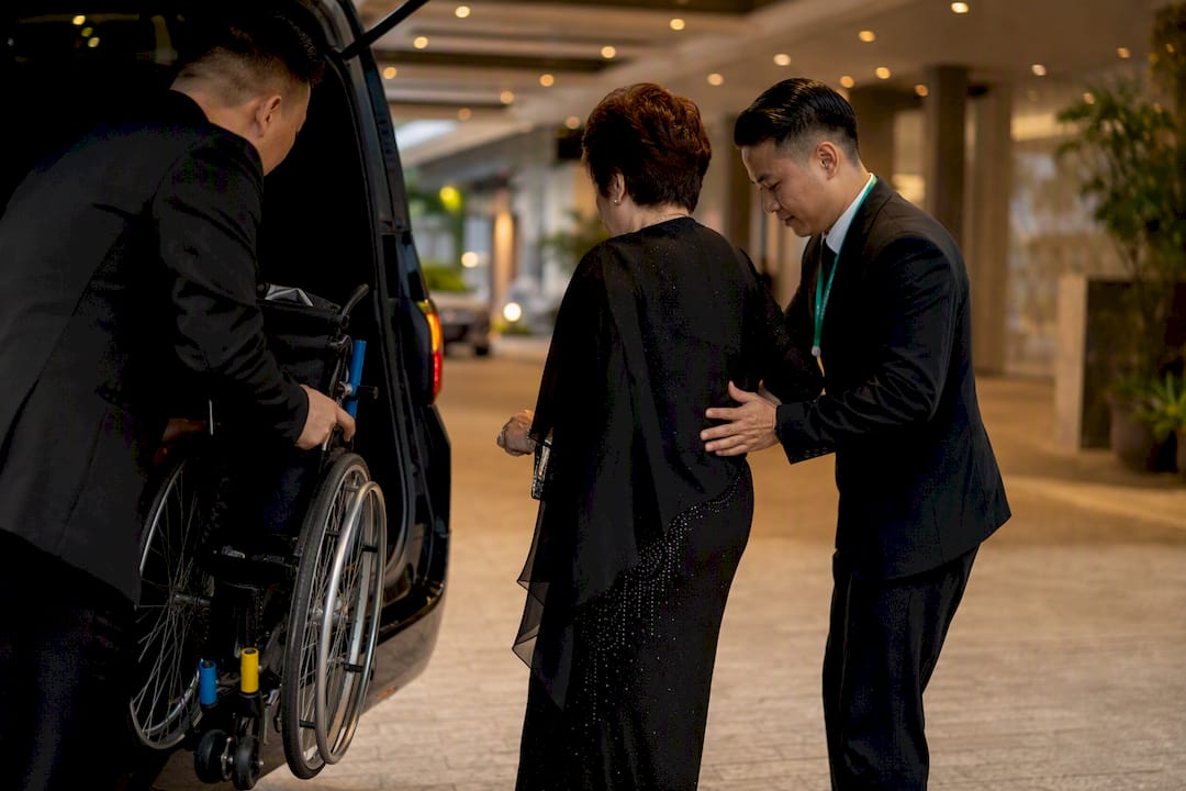 Chauffeur assisting guest with wheelchair