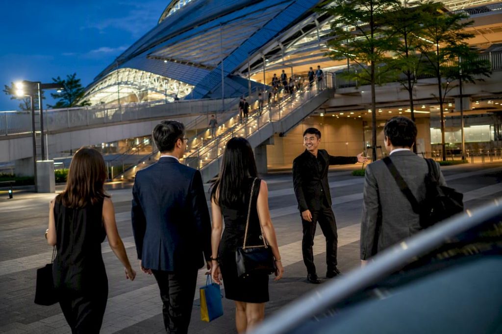 Visitors meeting transfer coordinator outside Sports Hub
