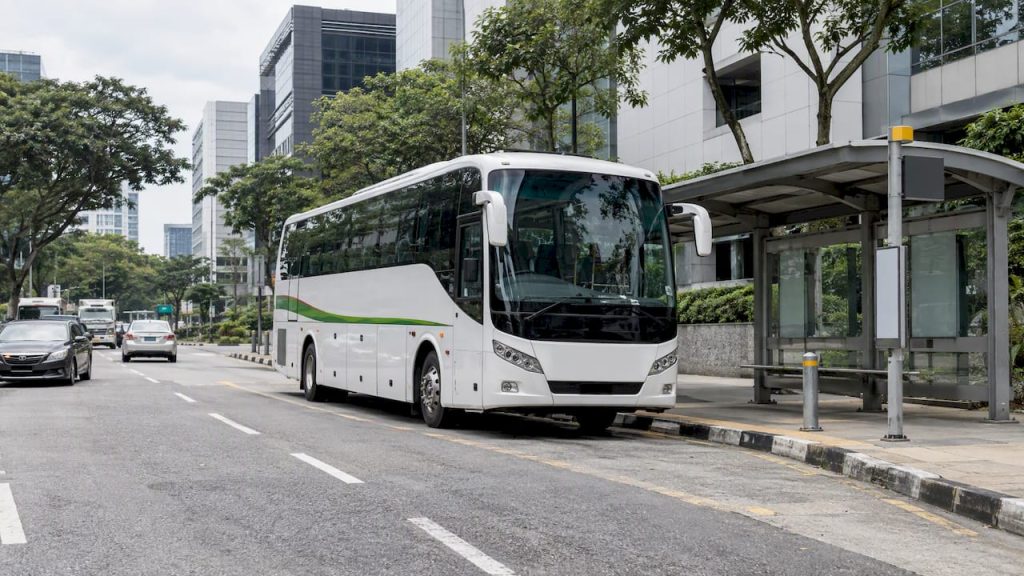 Shuttle coach beside a Singapore public stop